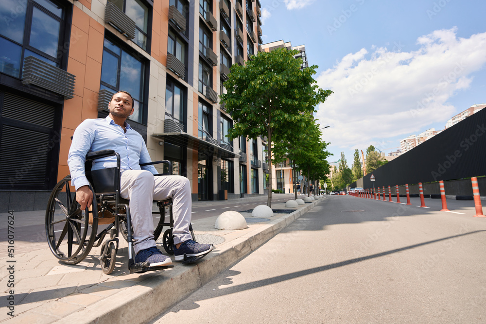 Serious wheelchair-bound person attempting to cross street Serious wheelchair-bound person attempting to cross street