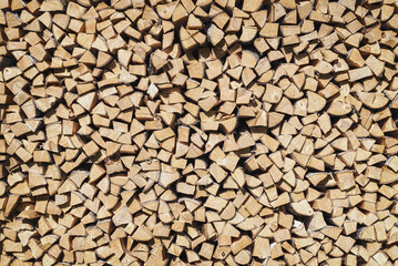 Fototapete Brennholz Textur The texture of chopped firewood in a pallet.. Wooden background..  © delobol