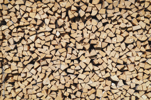 The texture of chopped firewood in a pallet.. Wooden background..