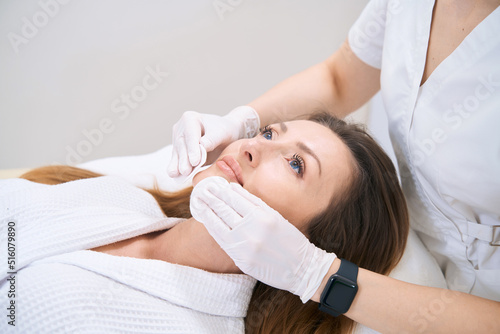 Facial cleansing with cotton swabs in clinic