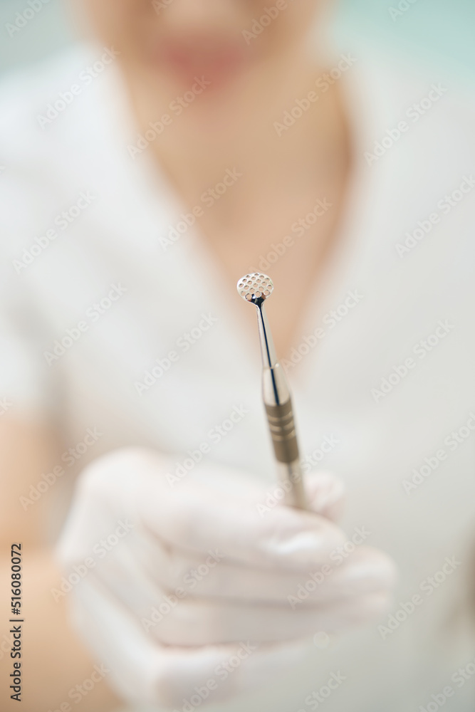 Female doctor is showing uno spoon close up Female doctor is showing uno spoon close up