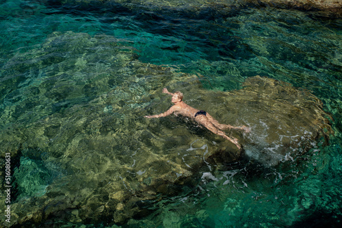 woman swims in clear water