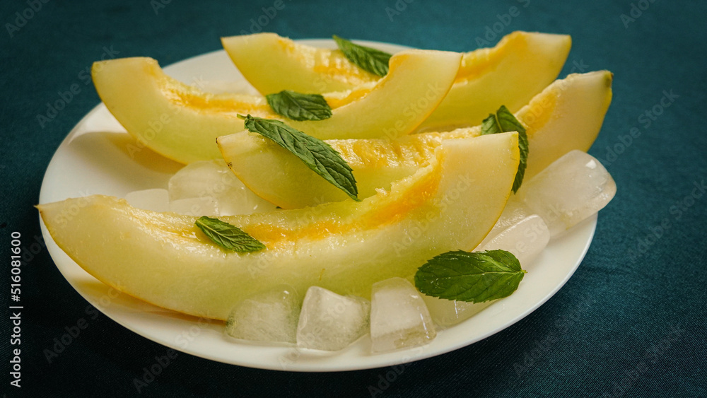 ripe melon with crushed ice and mint leaves, cut into pieces and slices ripe melon with crushed ice and mint leaves, cut into pieces and slices