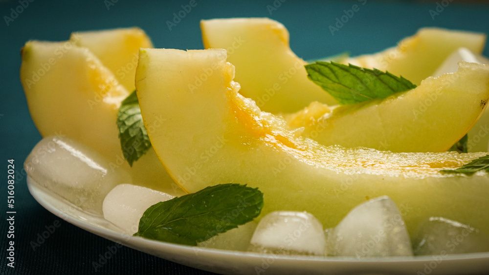 ripe melon with crushed ice and mint leaves, cut into pieces and slices ripe melon with crushed ice and mint leaves, cut into pieces and slices