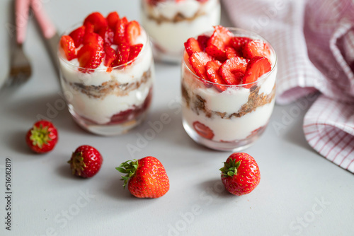 delicious homemade dessert with cream and strawberries in a glass