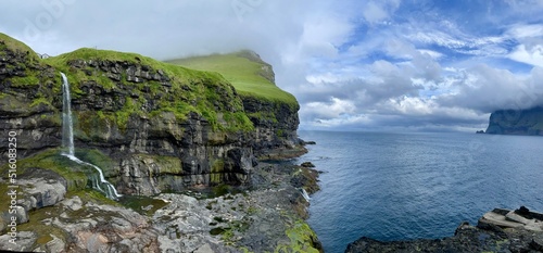 Beautiful waterfall falling down from a cliff in Faroe islands