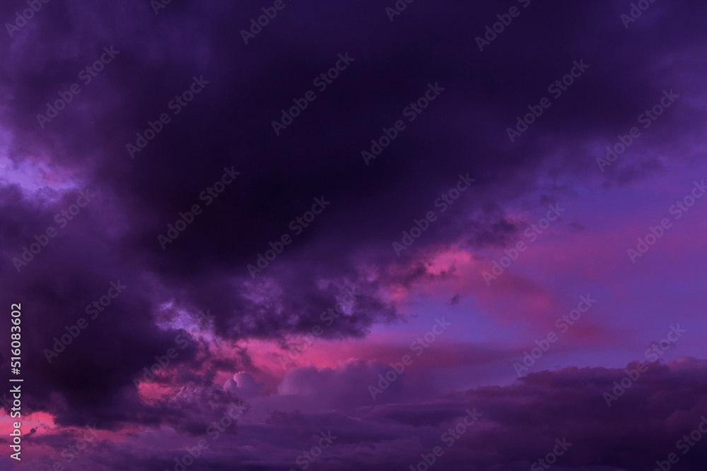 Epic sunset sunrise pink storm sky. Dark blue violet cumulus thunderstorm rainy clouds background texture