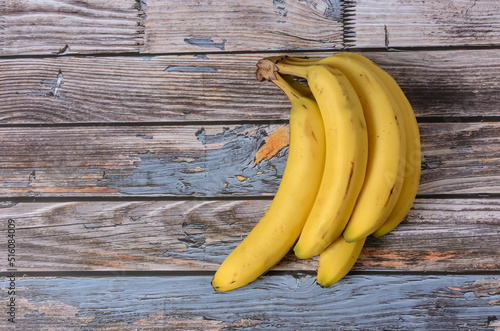 Group of ripe bananas on a wooden background.
