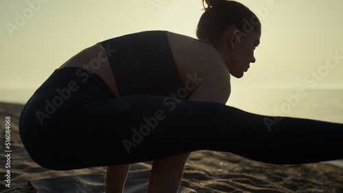 Billede på lærred Athletic woman standing arms spreading legs to sides practicing yoga close up