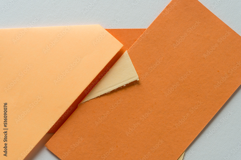 various shades of orange paper (some with folds) various shades of orange paper (some with folds)