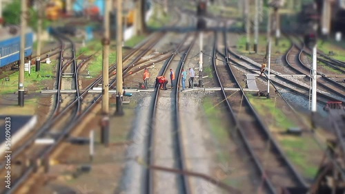 Railroad workers repairing a broken track. Time lapse. Tilt-shift effect. Miniature effect. Repairing railway. Rail tracks maintenance process. Mini train workers repair railroad