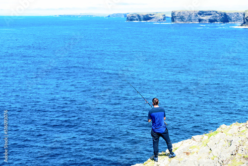 fishing on the Atlantic Ocean from high cliffs, Ireland. City of Limerick , 09 July 2022