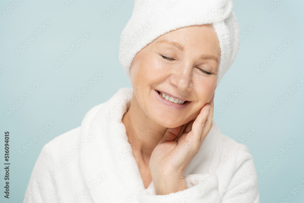 Beauty shot of senior woman in bathrobe after spa, her face with fresh skin and closed eyes Beauty shot of senior woman in bathrobe after spa, her face with fresh skin and closed eyes