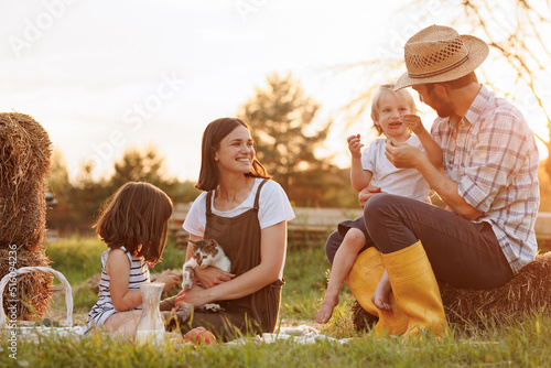 Vászonkép Happy young family having lunch at summer garden party