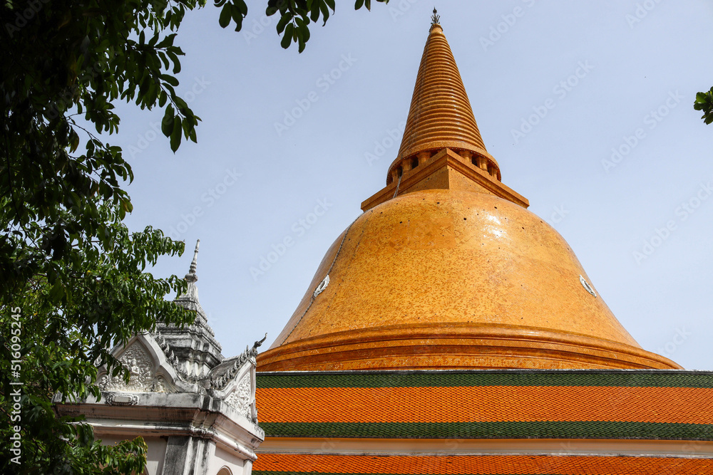 Golden pagoda, One of the holy places for Buddhists to respect and believe among the trees and the blue sky background.