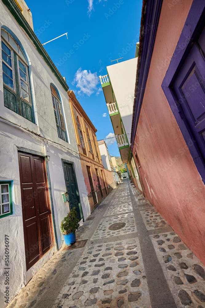 Scenic city street view of old historic houses and traditional residential buildings in an alleyway road in summer. Tourism abroad and overseas travel destinations in Santa Cruz, La Palma in Spain