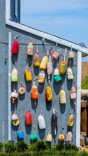 Buoys on a seaside home that are multicolored as a nautical display photo