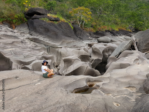 Woman sitting on the eroded rocks of Vale da Lua in Brazil photo