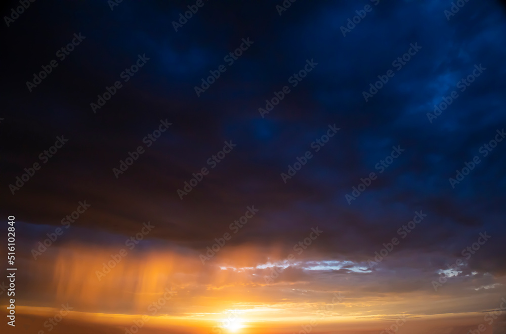 Stormy sky with dramatic clouds from an approaching thunderstorm at sunset