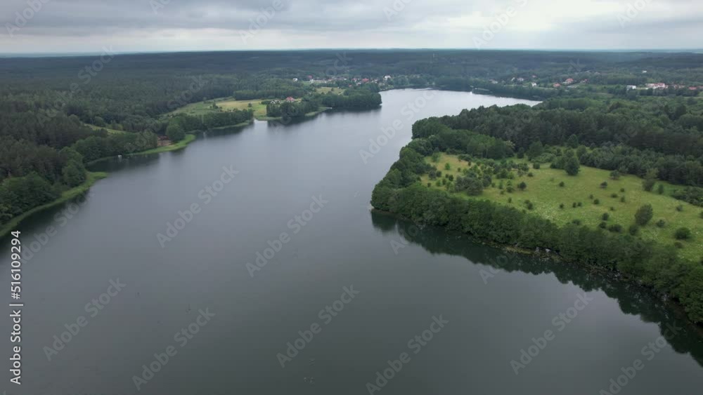 Spectacular Beautiful Lake Aerial View in Poland Village. Countryside with Woods and Lake in Europe. Dramatic Aerial View of Big Lake and Green Forest. Epic Amazing Nature Landscape Nature Reserve. Spectacular Beautiful Lake Aerial View in Poland Village. Countryside with Woods and Lake in Europe. Dramatic Aerial View of Big Lake and Green Forest. Epic Amazing Nature Landscape Nature Reserve.