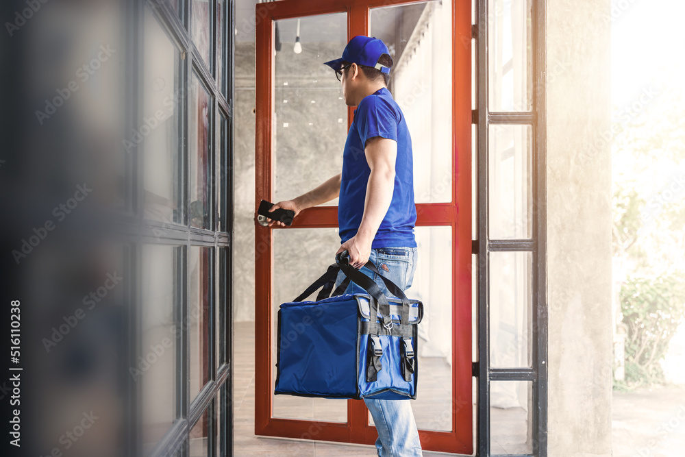 Delivery rider with food bag walk into customer delivery place. Delivery rider with food bag walk into customer delivery place.