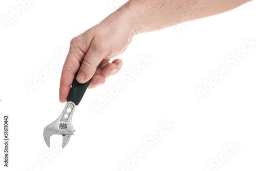Hand holds an adjustable wrench on a white background