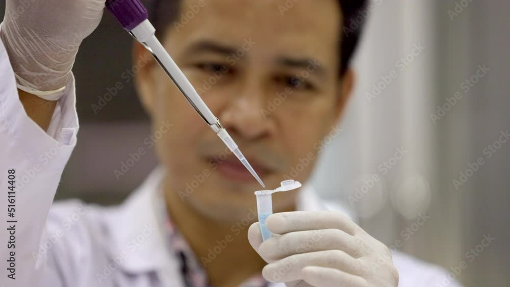 Scientist pipetting sample into vial for DNA testing. Scientist loads