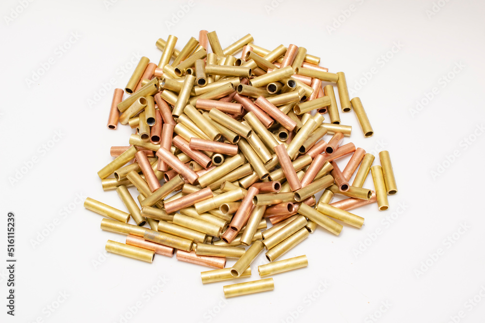 pile of copper pipes on a white background