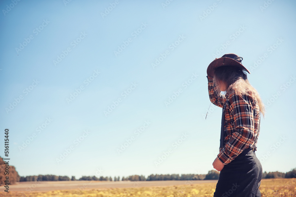 Cowboy with hat in a field in autumn Cowboy with hat in a field in autumn