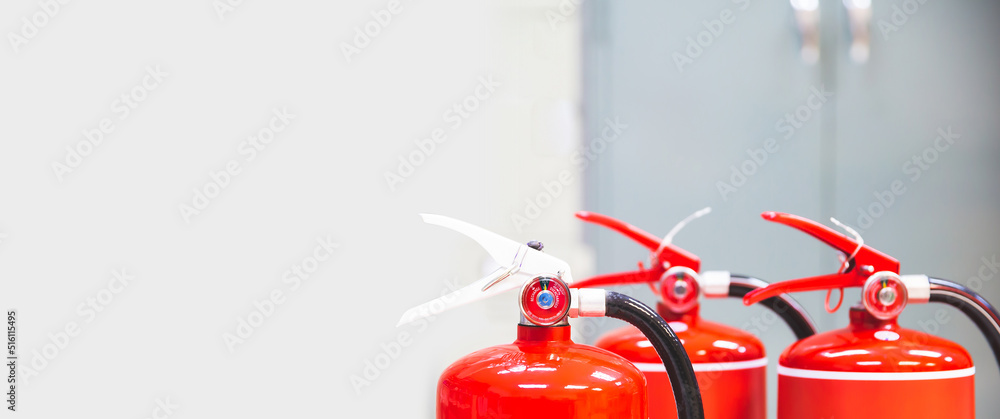 Naklejka premium Fire extinguisher, Close-up red fire extinguishers tank in the building for fire equipment for extinguishing or protection and prevent for emergency and safety rescue and alarm system training.
