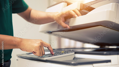 Photocopier printer, Close up hand office man press copy button on panel to using the copier or photocopy machine for scanning document or printing paper or Xerox a sheet.