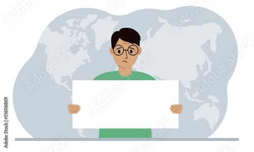 The concept of world attention. A man holds a white poster in his hands against the background of a world map.