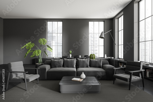 Front view on dark studio room interior with sofa, table