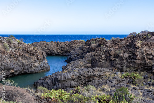 Scenic view on beach Playa El Barranco near Amarillo, Golf del Sur, Tenerife, Canary Islands, Spain, Europe, EU. Cliff and rock formation creating a beautiful turquoise lagoon meandering like river