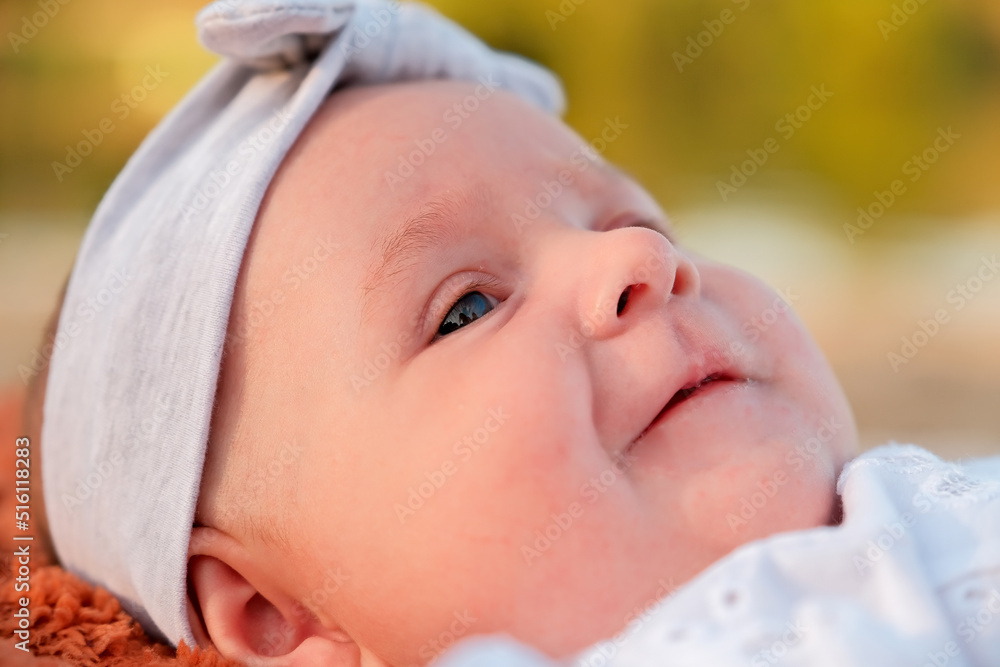 newborn baby girl lies on the beach. in a white dress. newborn baby girl lies on the beach. in a white dress.