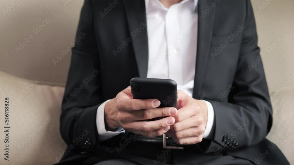 Close up male hands with mobile phone. Attractive stylish business man scrolling mobile phone at luxury hotel. Focused businessman reading good message at hotel room. Relaxed guy looking smartphone. Close up male hands with mobile phone. Attractive stylish business man scrolling mobile phone at luxury hotel. Focused businessman reading good message at hotel room. Relaxed guy looking smartphone.
