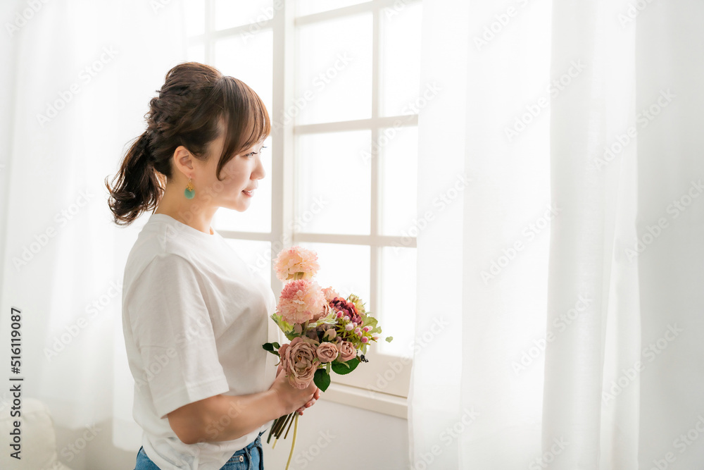 贈り物の花束を持つ日本人女性の横顔（母の日・プレゼント）
