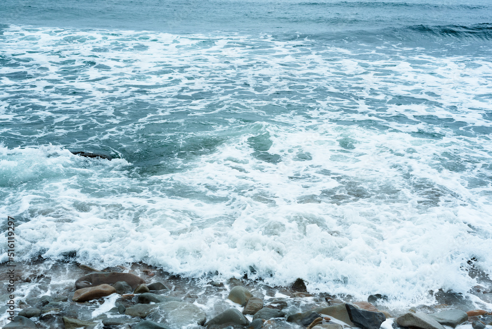 Nature background with sea waves hitting the sea shore. Scenic view of sea against cloudy sky Nature background with sea waves hitting the sea shore. Scenic view of sea against cloudy sky