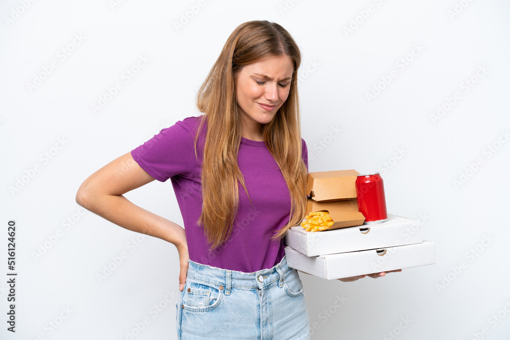 Young pretty blonde woman holding fast food isolated on white background suffering from backache for having made an effort Young pretty blonde woman holding fast food isolated on white background suffering from backache for having made an effort