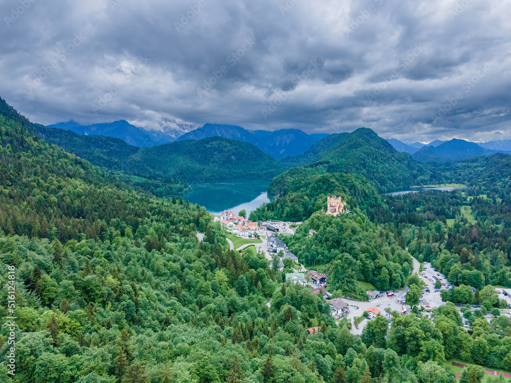 Bavarian Castle embedded in green forest and mountains 