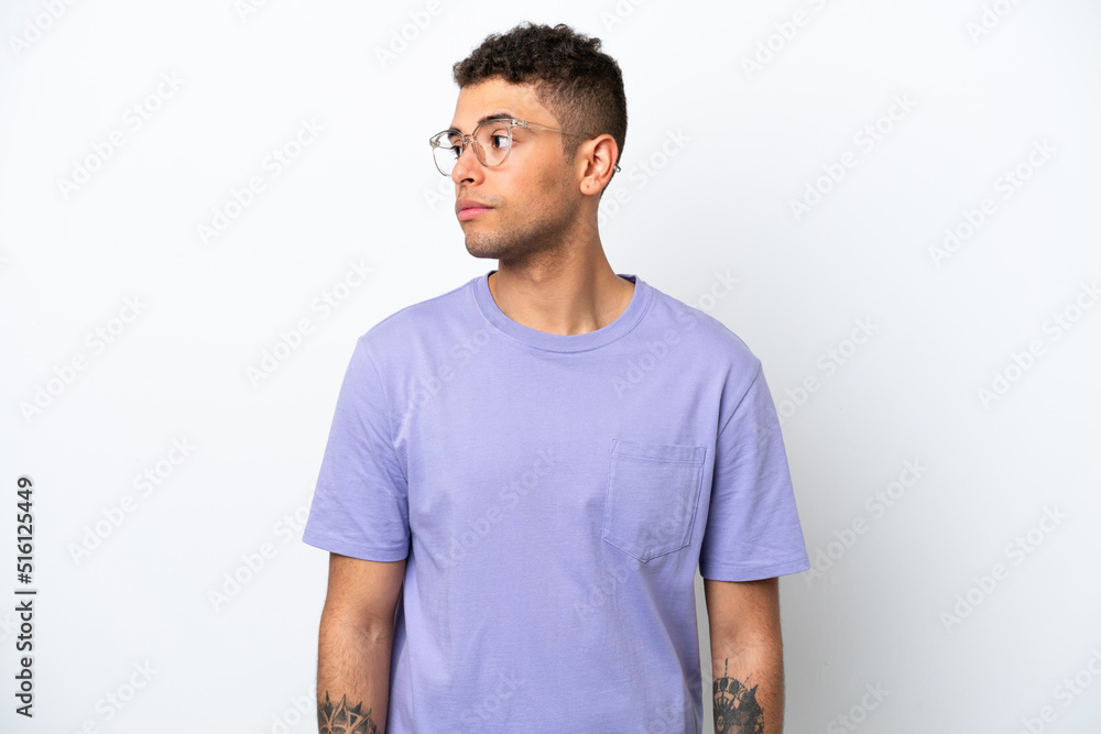 Young caucasian Brazilian man isolated on white background looking to the side Young caucasian Brazilian man isolated on white background looking to the side