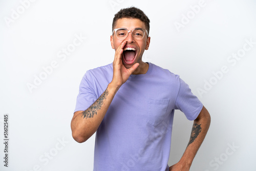 Young caucasian Brazilian man isolated on white background shouting with mouth wide open