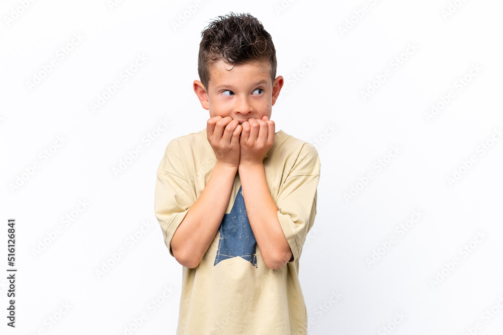 Little caucasian boy isolated on white background nervous and scared putting hands to mouth Little caucasian boy isolated on white background nervous and scared putting hands to mouth