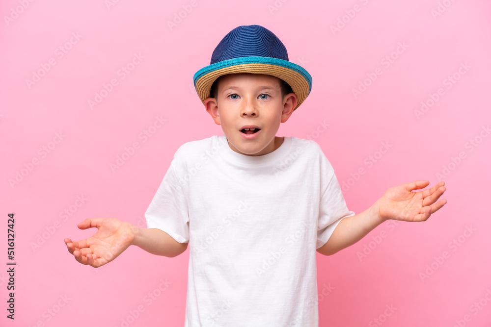 Little caucasian boy wearing a hat isolated on pink background with shocked facial expression Little caucasian boy wearing a hat isolated on pink background with shocked facial expression