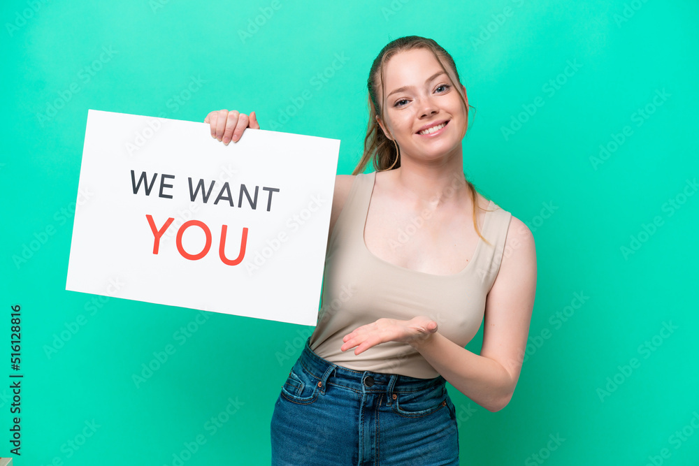 Young caucasian woman isolated on green background holding We Want You board making a deal Young caucasian woman isolated on green background holding We Want You board making a deal