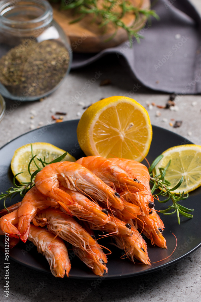 Shrimps on stone background. Grilled prawns with rosemary and lemon. Shrimps on stone background. Grilled prawns with rosemary and lemon.