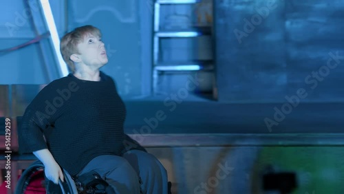 Theatrical performance. Woman in a wheelchair is looking for a way out