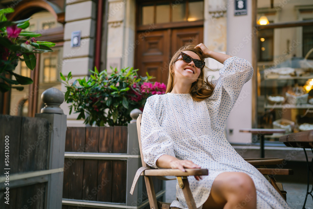 Young Woman chilling in cozy cafe, looking around , happy emotions. Traveling woman. Young Woman chilling in cozy cafe, looking around , happy emotions. Traveling woman.