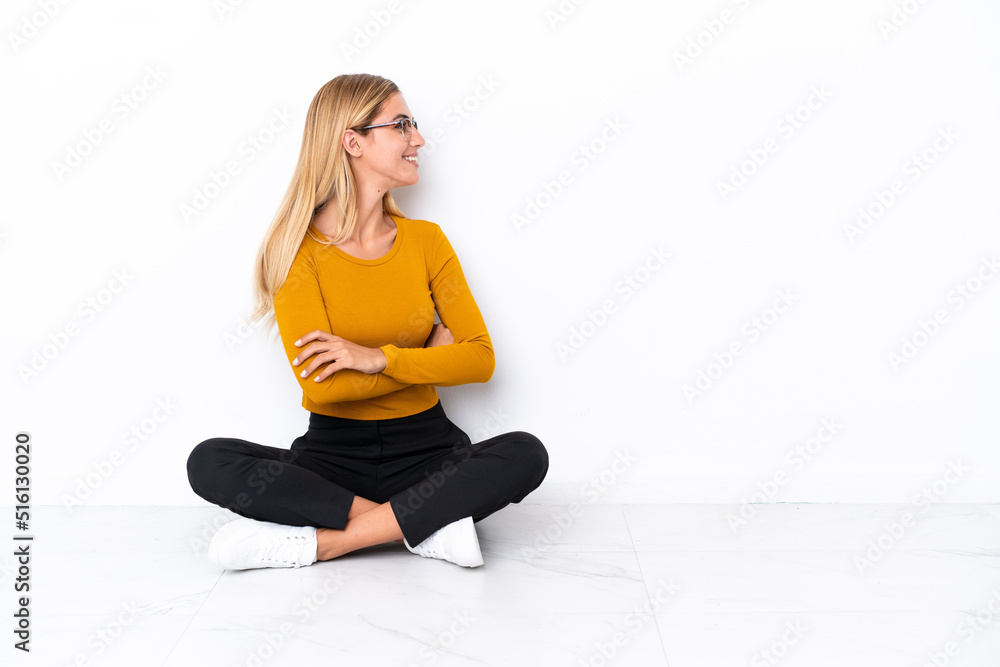 Blonde Uruguayan girl sitting on the floor in lateral position Blonde Uruguayan girl sitting on the floor in lateral position