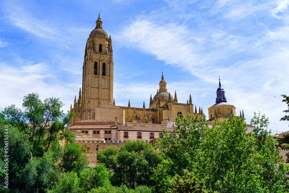 View of the impressive cathedral of Segovia with its high tower rising into the sky, Spain. View of the impressive cathedral of Segovia with its high tower rising into the sky, Spain.